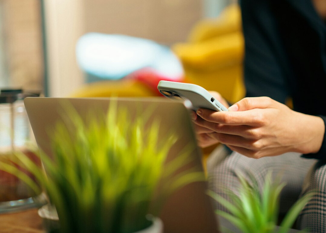 person scrolling smartphone at home